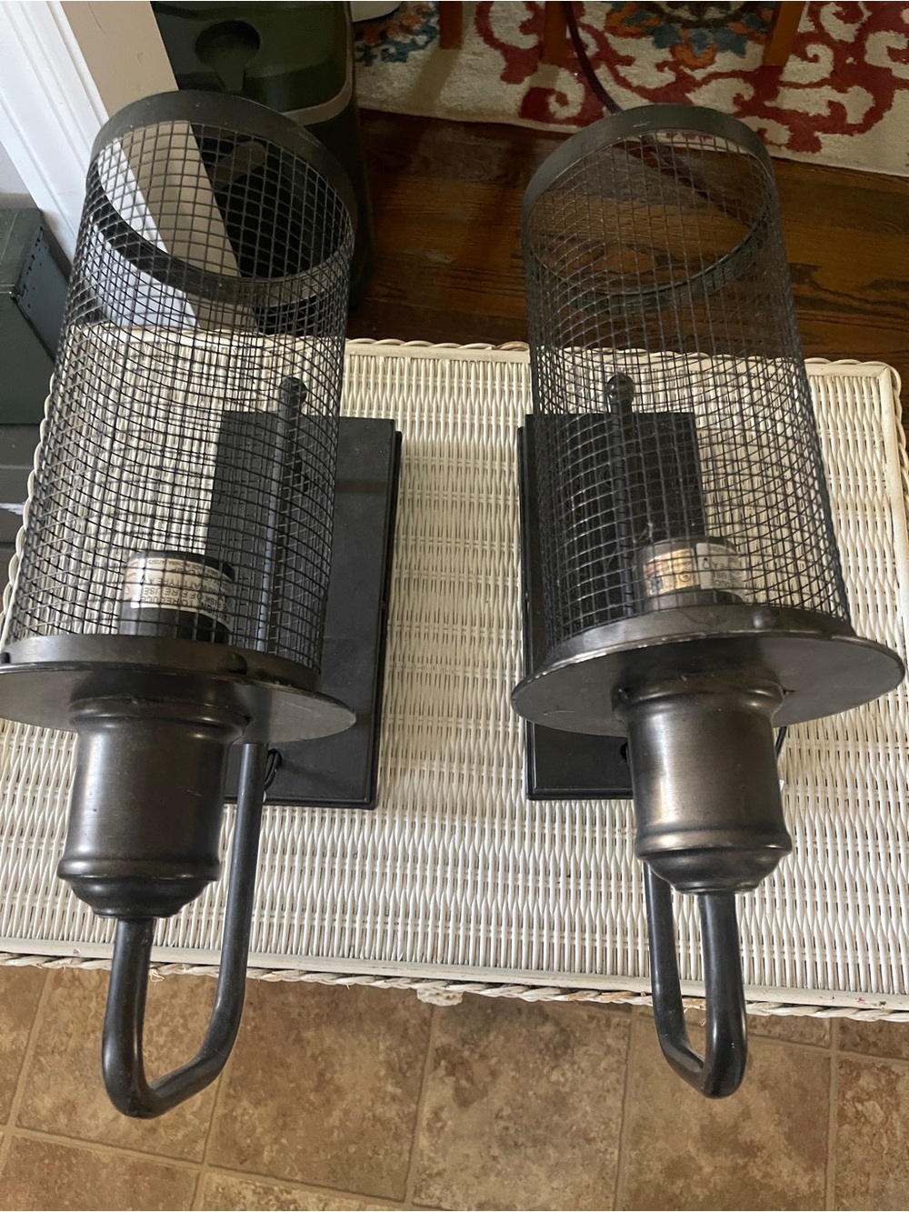Metal Cage Wall Sconces in Blackish / Oiled bronze dark brown.